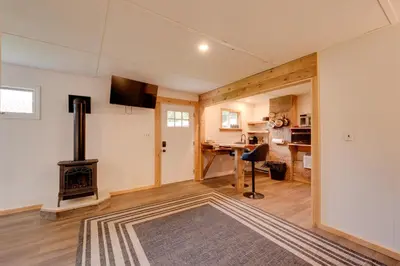 a living room with a fireplace and a desk at Deluxe Cabin A at Elk Creek Escape Pet Friendly! in Hillsgrove