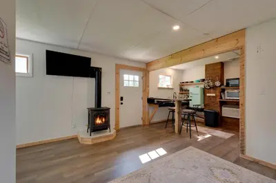 a living room with a fireplace and a stove at Hillsgrove Deluxe Cabin E Close to Hiking in Hillsgrove