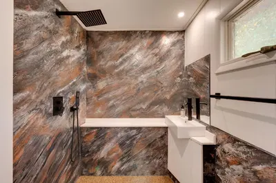 a bathroom with a stone wall at Hillsgrove Deluxe Cabin E Close to Hiking in Hillsgrove
