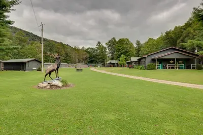 a statue of a deer on a rock in a field at Hillsgrove Deluxe Cabin E Close to Hiking in Hillsgrove