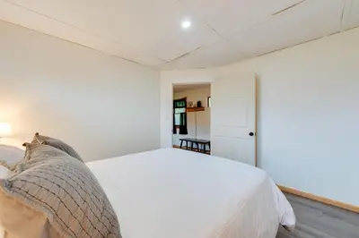a white bedroom with a bed and a closet at Pet-Friendly Deluxe Cabin F with Grill in Hillsgrove in Hillsgrove