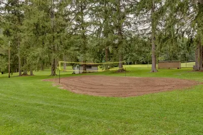 a park with a volley ball hoop in the grass at Pet-Friendly Deluxe Cabin F with Grill in Hillsgrove in Hillsgrove