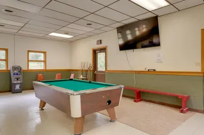 a room with a pool table and a flat screen tv at Pet-Friendly Deluxe Cabin F with Grill in Hillsgrove in Hillsgrove