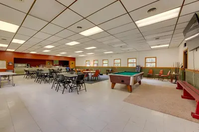 a room with tables and chairs and a pool table at Deluxe Cabin G 9 Mi to Worlds End State Park! in Hillsgrove