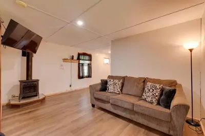 a living room with a couch and a fireplace at Deluxe Cabin G 9 Mi to Worlds End State Park! in Hillsgrove
