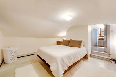a white bedroom with a bed and a window at The Big House at Elk Creek Escape with Game Room in Hillsgrove