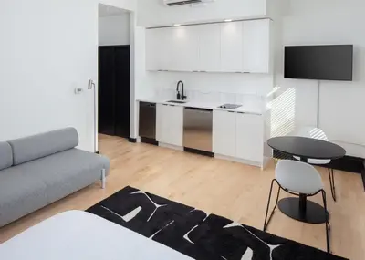 a kitchen and living room with a couch and a table at Kasa The Niche University City Philadelphia in Philadelphia