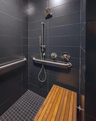 a shower with a wooden bench in a bathroom at Kasa The Niche University City Philadelphia in Philadelphia