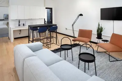 a living room with a couch and chairs and a table at Kasa The Niche University City Philadelphia in Philadelphia