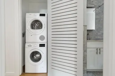 a laundry room with a washer and dryer at Blueground Midtown gym elev nr Grand Central NYC-1479 in New York