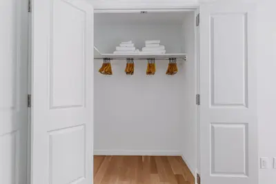 an empty closet with white walls and white doors at Blueground Midtown gym elev nr Grand Central NYC-1479 in New York