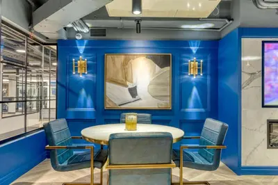 a dining room with blue walls and a table and chairs at Blueground Midtown gym elev nr Grand Central NYC-1479 in New York