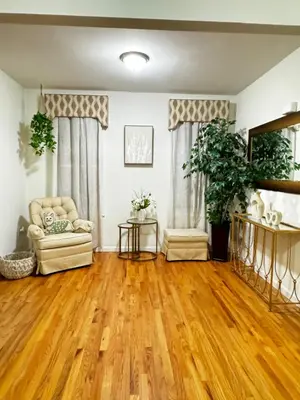 a living room with wooden floors and a couch at Private 1st floor Apartment - Only 5 min Away from Newark Airport and 30 min to NYC in Elizabeth