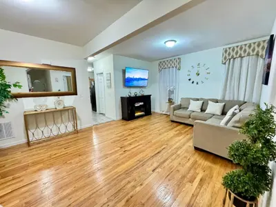 a living room with a couch and a tv at Private 1st floor Apartment - Only 5 min Away from Newark Airport and 30 min to NYC in Elizabeth