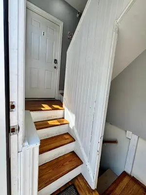 a staircase in a house with a white door at Private 1st floor Apartment - Only 5 min Away from Newark Airport and 30 min to NYC in Elizabeth