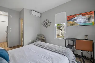 a bedroom with a bed and a desk in it at Cottage Suites in Middletown