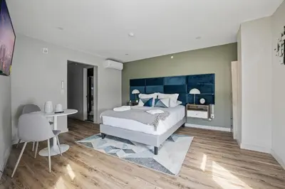 a bedroom with a bed and a table and chairs at Cottage Suites in Middletown