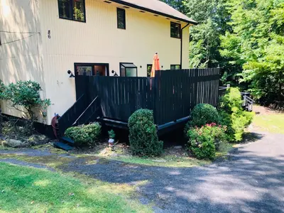a house with a black fence in front of it at Bethel Escape Hot Tub 4 beds Game Room and Fire pit Fully Stocked Kitchen in Smallwood