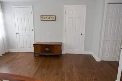 an empty room with two white doors and a table at Spacious Modern Home in West Freehold in Stonehurst West