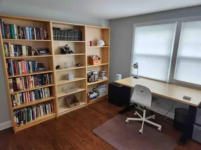 an office with a desk and book shelves with books at Spacious Modern Home in West Freehold in Stonehurst West