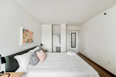 a bedroom with a large white bed with pink pillows at PP 2107 Beautiful 1Br Apartment I Free Parking in Harrisburg