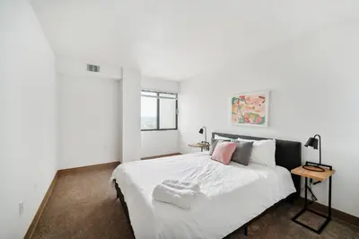 a bedroom with a large white bed and a table at PP 2107 Beautiful 1Br Apartment I Free Parking in Harrisburg