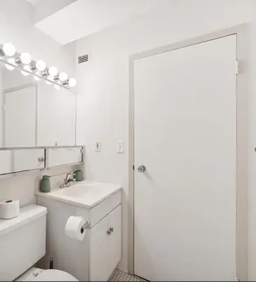 a bathroom with a toilet and a sink and a mirror at PP 2107 Beautiful 1Br Apartment I Free Parking in Harrisburg