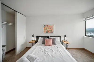 a bedroom with a large bed with two tables at PP 2312 Modern Corporate 1br, pool, Gym in Harrisburg