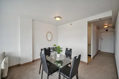 a dining room with a glass table and black chairs at PP 2312 Modern Corporate 1br, pool, Gym in Harrisburg