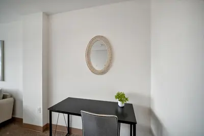a dining room with a black table and a mirror at PP 2312 Modern Corporate 1br, pool, Gym in Harrisburg