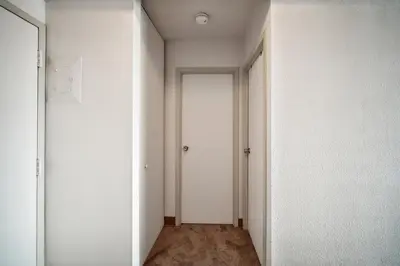 an empty hallway with white walls and a door at PP 2312 Modern Corporate 1br, pool, Gym in Harrisburg