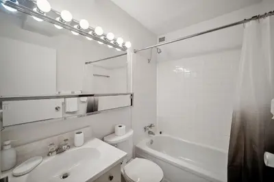 a white bathroom with a sink and a toilet at PP 2312 Modern Corporate 1br, pool, Gym in Harrisburg