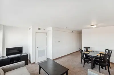a living room with a table and a couch at PP 2401 Modern Corporate 2br Suite pool, Gym in Harrisburg