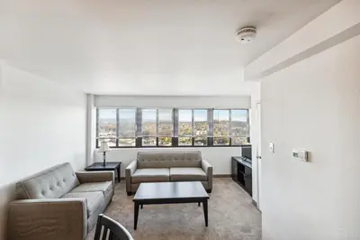 a living room with two couches and a table at PP 2401 Modern Corporate 2br Suite pool, Gym in Harrisburg