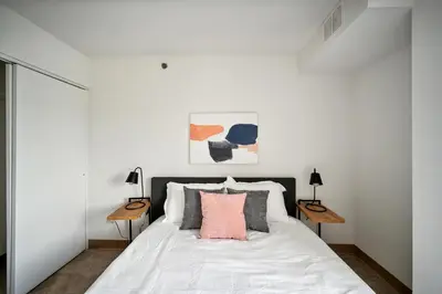 a bedroom with a white bed with two tables at PP 501 Harrisburg Gem 2br, Pool, Parking in Harrisburg
