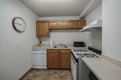 a kitchen with a stove and a clock on the wall at PP 501 Harrisburg Gem 2br, Pool, Parking in Harrisburg