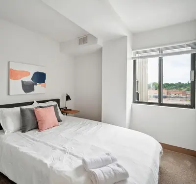 a white bedroom with a large bed with a window at PP 501 Harrisburg Gem 2br, Pool, Parking in Harrisburg