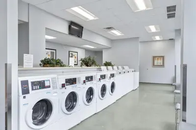 a laundry room with a row of washing machines at PP 501 Harrisburg Gem 2br, Pool, Parking in Harrisburg