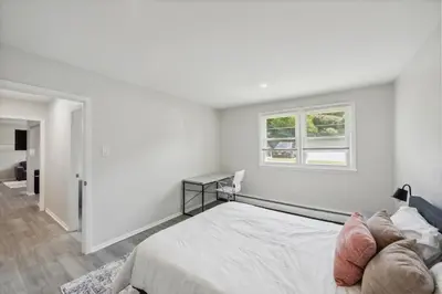 a white bedroom with a bed and a window at Pine Brook 1019 I Modern 15Br Apartment ! Pool in Newark