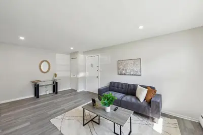 a living room with a couch and a table at Pine Brook 1019 I Modern 15Br Apartment ! Pool in Newark