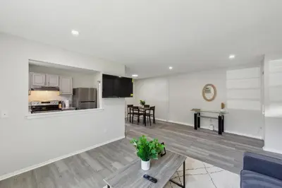 a living room with a couch and a table at Pine Brook 1019 I Modern 15Br Apartment ! Pool in Newark