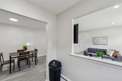 a living room with a table and a couch at Pine Brook 1019 I Modern 15Br Apartment ! Pool in Newark