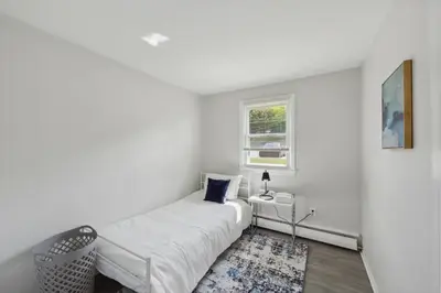 a white bedroom with a bed and a window at Pine Brook 1019 I Modern 15Br Apartment ! Pool in Newark