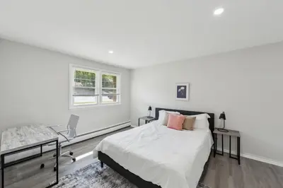 a white bedroom with a bed and a desk at Pine Brook 1019 I Modern 15Br Apartment ! Pool in Newark