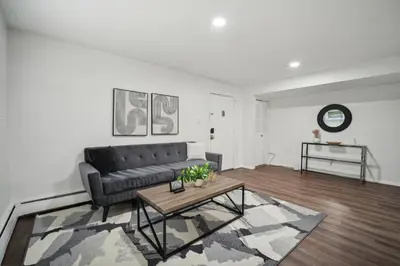 a living room with a couch and a coffee table at Pine Brook 104 I Pool Gym I Free Parking ! in Newark
