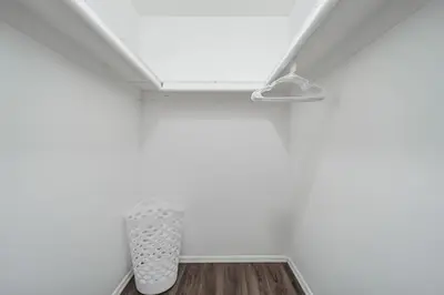 a white room with a white ceiling and a wooden floor at Pine Brook 104 I Pool Gym I Free Parking ! in Newark