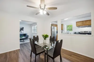 a dining room with a table and a ceiling fan at Pine Brook 1108 I Pool Gym I Free Parking ! in Newark