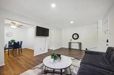 a living room with a couch and a table at Pine Brook 1108 I Pool Gym I Free Parking ! in Newark