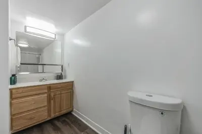 a bathroom with a sink and a toilet and a mirror at Pine Brook 1122 I Pool Gym I Free Parking ! in Newark