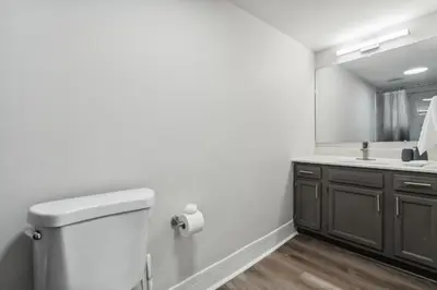 a bathroom with a toilet and a sink at Pine Brook 118 I Modern Corporate 2bd I Parking in Newark